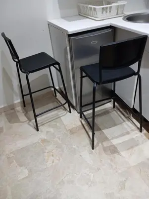 two black chairs sitting next to a desk and a sink at Palace appart Marrakech - hivernage in Marrakech