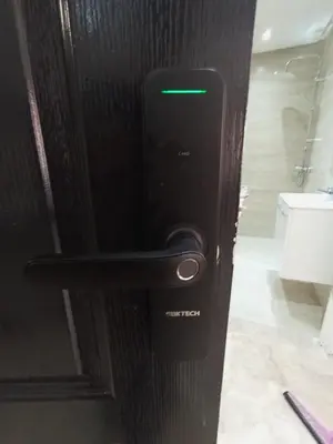 a black door with a green light on it at Palace appart Marrakech - hivernage in Marrakech