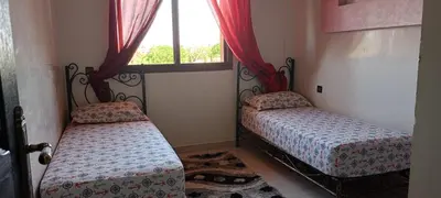 a bedroom with two beds and a window at dar rita in Marrakech