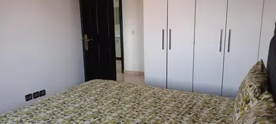 a bedroom with a bed and some white cabinets at dar rita in Marrakech