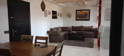 a living room with a couch and a table at dar rita in Marrakech