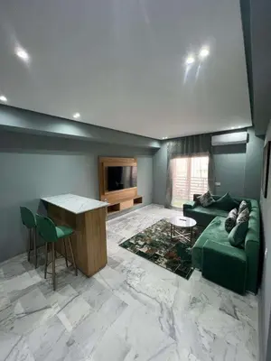 a living room with a green couch and a table at Appartement Palace B in Marrakech