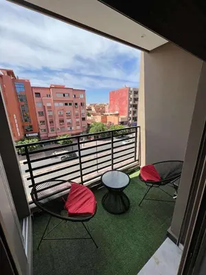 a balcony with four chairs and a table on a balcony at Appartement Palace B in Marrakech