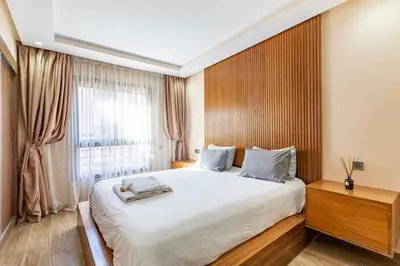 a bedroom with a large white bed and a window at New! Appt Spacieux et Lumineux à Menara Garden in Marrakech