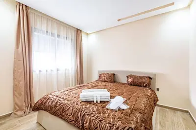 a bedroom with a large bed with a large window at New! Appt Spacieux et Lumineux à Menara Garden in Marrakech
