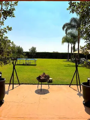 a fire pit in a park with a field at Palais Ona in Marrakech