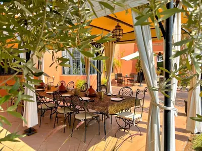 a table and chairs sitting under an open patio at Palais Ona in Marrakech