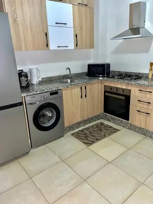 a kitchen with a washing machine and a sink at Bel Appartement nour 5 in Marrakech