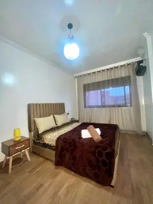 a small bedroom with a bed and a window at Bel Appartement nour 5 in Marrakech
