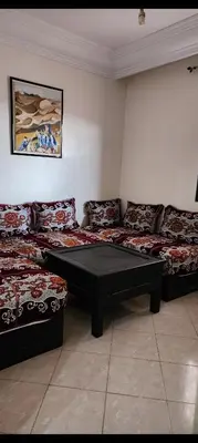 a room with two beds and a table in it at Apparemment a Marrakech très agr in Marrakech