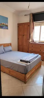 a bedroom with a large bed and a dresser at Apparemment a Marrakech très agr in Marrakech