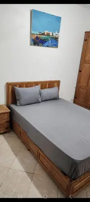 a bed in a bedroom with a picture on the wall at Apparemment a Marrakech très agr in Marrakech