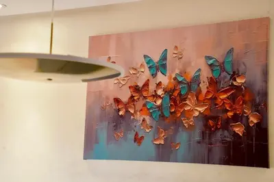 a painting of butterflies hanging on a wall at Appartement 2 chambres perle 24 in Marrakech