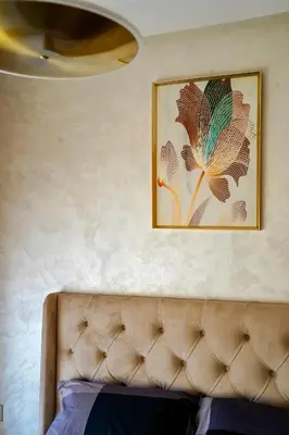 a couch in a room with a picture on the wall at Appartement 2 chambres perle 24 in Marrakech