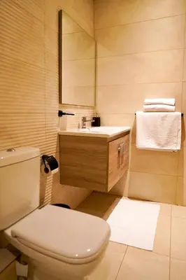 a bathroom with a white toilet and a sink at Appartement 2 chambres perle 24 in Marrakech