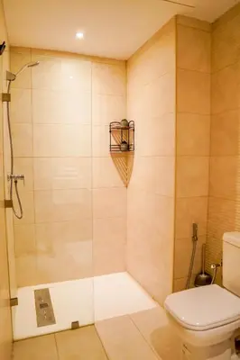 a bathroom with a shower and a toilet at Appartement 2 chambres perle 24 in Marrakech
