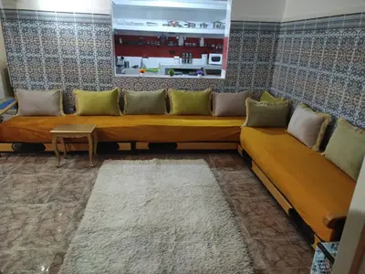 a living room with a couch and a table at Appartement de luxe in Marrakech