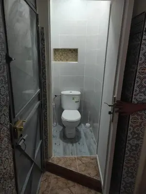 a bathroom with a toilet in a small room at Appartement de luxe in Marrakech