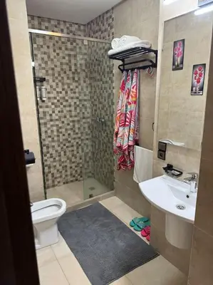 a bathroom with a shower and a toilet and a sink at Appartement à Gueliz près de toute commodité in Marrakech