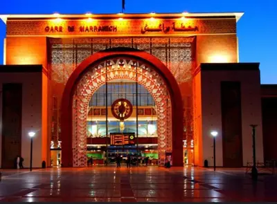 a large building with an arch with a clock on it at Appartement au centre de gueliz in Marrakech
