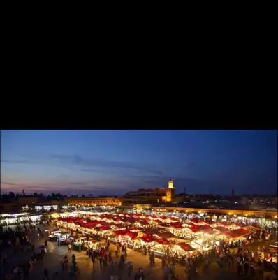 a large crowd of people with red umbrellas at night at Appartement au centre de gueliz in Marrakech