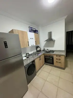 a kitchen with a stainless steel refrigerator and a dishwasher at Appartement au centre de gueliz in Marrakech