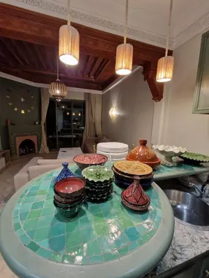 a table with different colored vases on top of it at les jardins de la palmeraie 2 appart in Marrakech