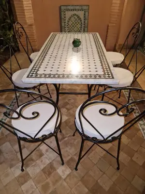 a table with two chairs and a table with a table at les jardins de la palmeraie 2 appart in Marrakech