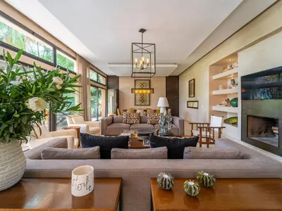 a living room with a large couch and a fireplace at Villa Albatros in Marrakech