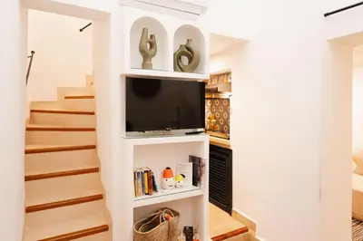 a living room with a tv in a white wall at Dar Coco 180 in Marrakech