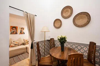a living room with a table and chairs and a couch at Dar Coco 180 in Marrakech