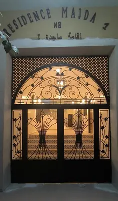 a gate with a window with a view of the ocean at La rose à côté Carry in Marrakech