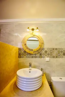 a bathroom with a white sink and a mirror at Riad Norakech nah zu allen Touristen-Attraktionenr in Marrakech