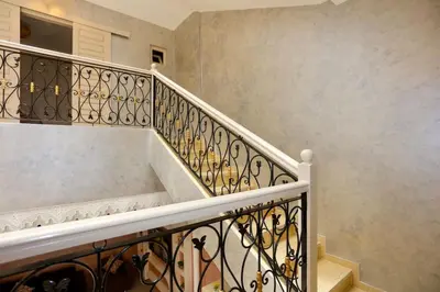 a set of stairs with a white railing at Riad Norakech nah zu allen Touristen-Attraktionenr in Marrakech