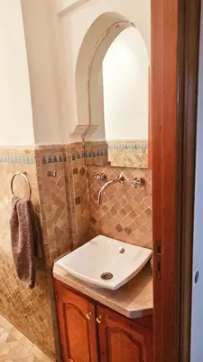 a bathroom with a sink and a mirror at Beautiful cozy apartment with pool in Marrakech