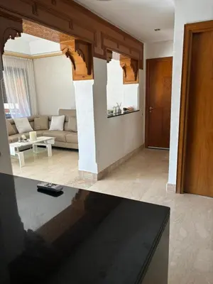 a living room with a couch and a table at Beautiful cozy apartment with pool in Marrakech