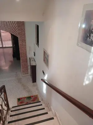 a staircase in a house with white walls at Villa Lmima Malika in Marrakech