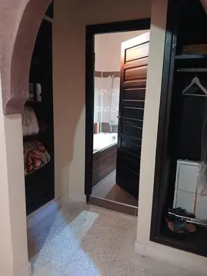 a bathroom with a mirror and a bath tub at Villa Lmima Malika in Marrakech