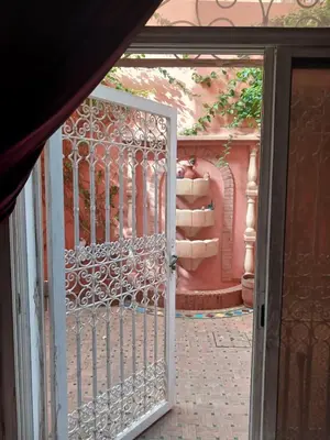 an open gate to a courtyard with a staircase at Villa Lmima Malika in Marrakech