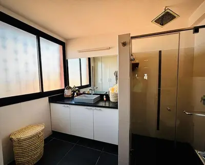 a bathroom with a counter and a sink and a shower at Jardin Majorelle Appartement in Marrakech