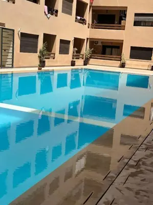 a large swimming pool in front of a building at Appartement Haut standing in Marrakech