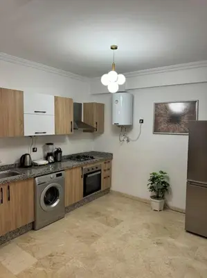 a kitchen with a sink and a dishwasher at Appartement Haut standing in Marrakech
