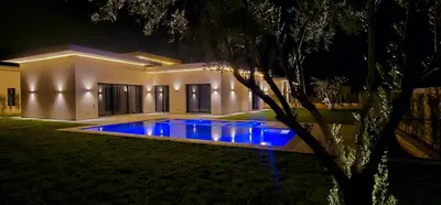 a swimming pool with blue lights in front of a house at Villa privée sans vis-vis in Marrakech