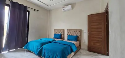 a bedroom with two beds with blue sheets and a window at Villa privée sans vis-vis in Marrakech
