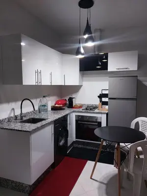 a kitchen with white cabinets and a sink and a dishwasher at Marrakech in Marrakech