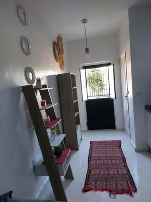a living room with a door and a rug and a shelf at Marrakech in Marrakech