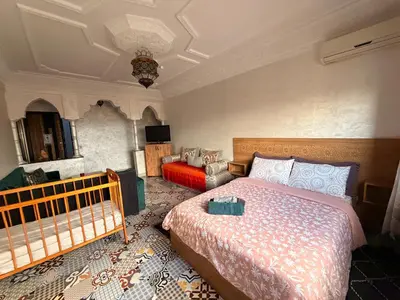 a bedroom with a bed and a couch at Julie Airport Marrakech Apartments in Marrakech