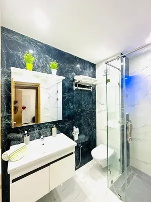 a bathroom with a sink and a shower and a toilet at Appart F3 de luxe à Gueliz - 5 min de la gare - Piscine, WiFi, parking au coeur de Marrakech in Marrakech