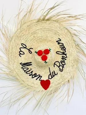 a straw hat with a hello kitty written on it at Appart F3 de luxe à Gueliz - 5 min de la gare - Piscine, WiFi, parking au coeur de Marrakech in Marrakech
