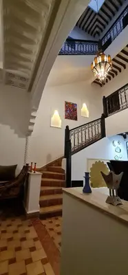 a lobby with stairs and a chandelier in a building at Riad Dar Fatna in Marrakech